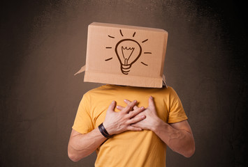 Young man gesturing with a cardboard box on his head with light