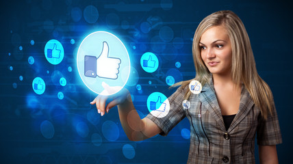 Young businesswoman pressing thumbs up button on modern social n