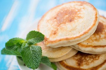 Close-up of pancakes with mint leaves, studio shot