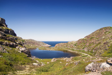 Mountain lake in the North. Moss-covered hills, and stunted vege