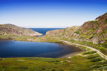 Mountain lake in the North. Moss-covered hills, and stunted vege