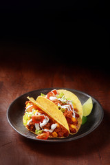 Mexican taco with spicy meat and salad