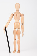 Small wood mannequin standing with colour pencil isolated on whi