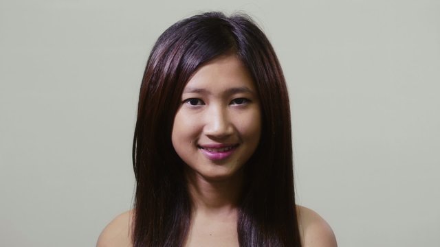 Portrait of asian woman looking at camera, young people