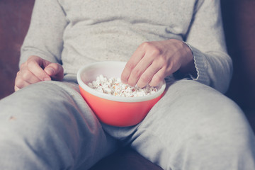 Young man eating popcorn