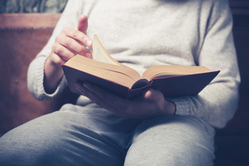 Man fliping through big book