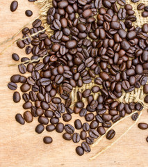 Fresh coffee beans on wood background