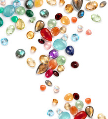 Many colorful real gemstones on the white background.