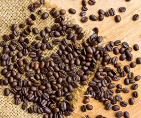 Fresh coffee beans on wood background