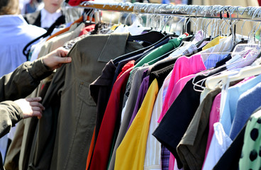 clothes on a rack in a flea market - 64252494