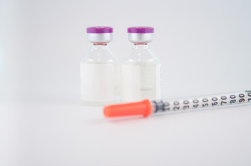 Disposable syringe and Purple cap of medicine injection vial