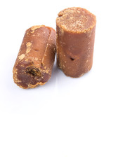 Brown coconut sugar over white background