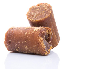 Brown coconut sugar over white background