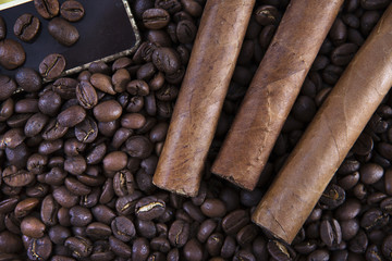 Three cigar on coffee beans close-up