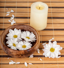 Spa decoration with candle and daisies