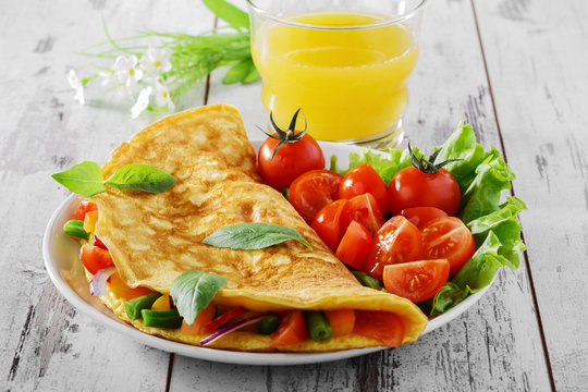 omelet with vegetables and cherry tomatoes