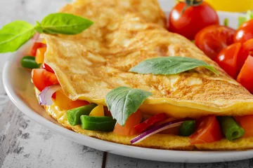 Wall murals Fried eggs omelet with vegetables and cherry tomatoes