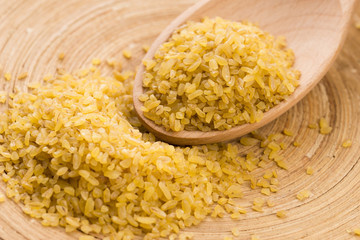 bulgur wheat in wooden spoon