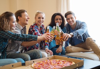 Group of young friends celebrating in home interior