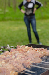 Meat kebabs cooking over a summer BBQ