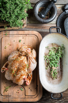 Preparing roast chicken with herbs