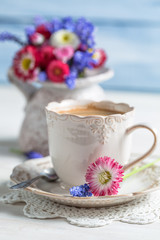 Cup of hot coffee and spring flowers