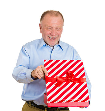 Good gift ideas. Portrait happy senior man opening xmas box