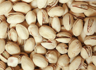 Closeup of pistachios in nut shells as food background