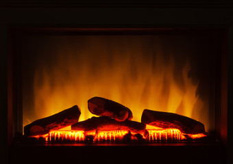 Closeup of electric artificial fireplace orange fire interior
