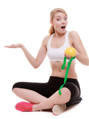 fit woman with measure tape fruit. Time for diet slimming.