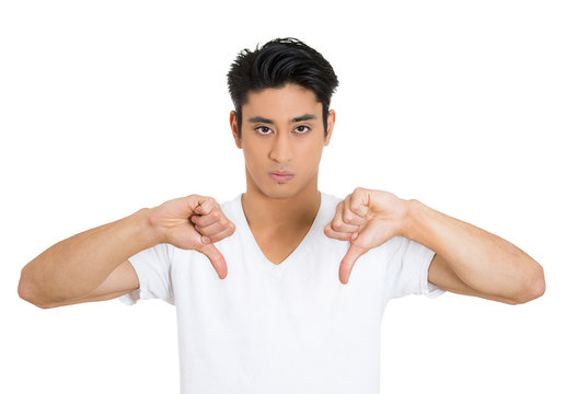 Portrait young man showing Thumbs down hand gesture