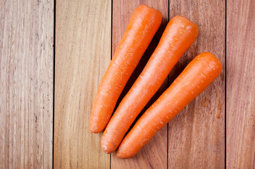 Bunch of fresh carrots over wooden