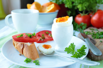 Boiled egg with crunchy bread and vegetables for breakfast