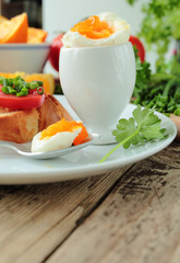 Boiled egg for breakfast with fresh crunchy bread