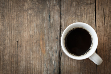 A white coffee cup on a brown wooden table background