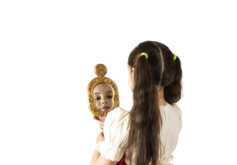 Young girl looking in the mirror