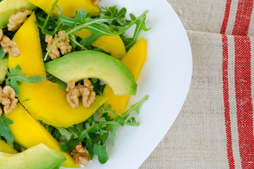 Salad with mango, avocado, rucola and walnuts
