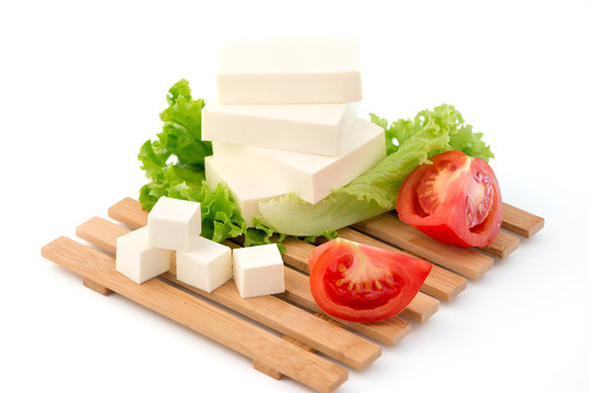 Sliced feta cheese with salad and tomatos
