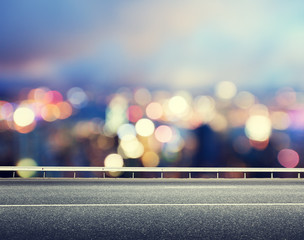 Asphalt road and blurred modern city