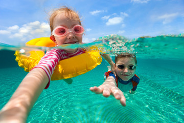 Kids having fun swimming on summer vacation