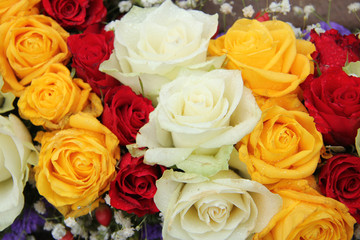 yellow, white and red roses in a wedding arrangement