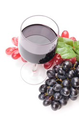 Glass of black wine and grapes on white background