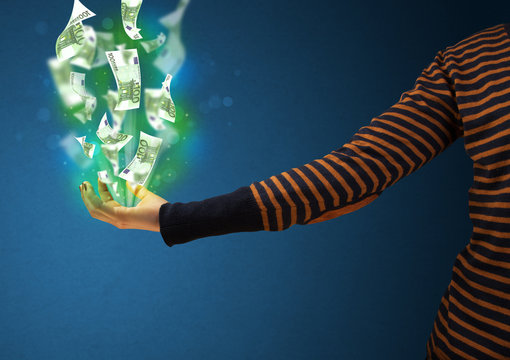 Glowing money in the hand of a woman