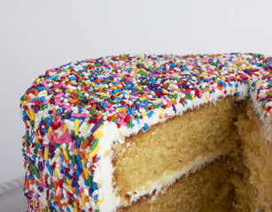 Sliced layer cake with sprinkles