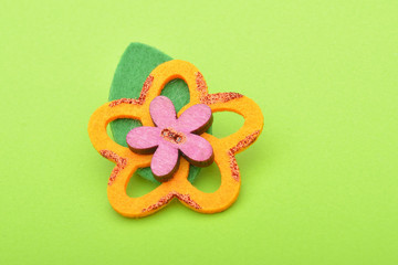 Felt flowers brooch on green