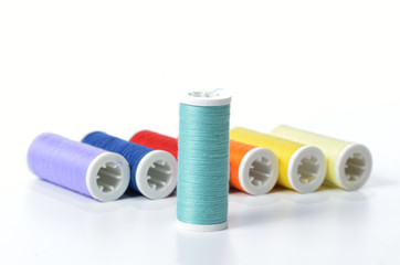 Colorful sewing threads isolated on white background