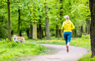 Woman running in summer park - 64297486