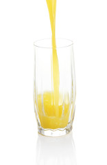Juice pouring into glass isolated on white