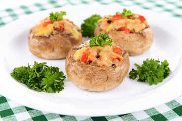 Stuffed mushrooms on plate on table close-up