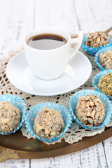Set of chocolate candies, on tray, on color wooden background